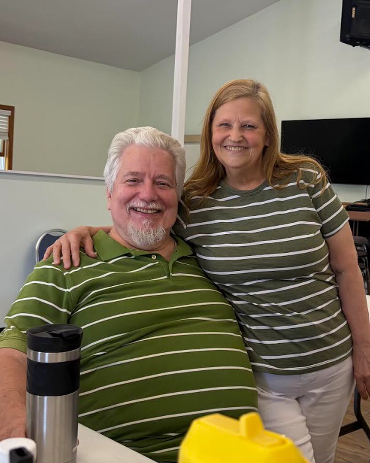A couple from the congregation smiling in the fellowship hall